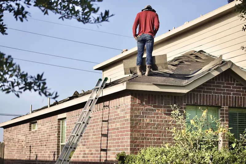 Professional roofer working on a residential roof in Port of Long Beach